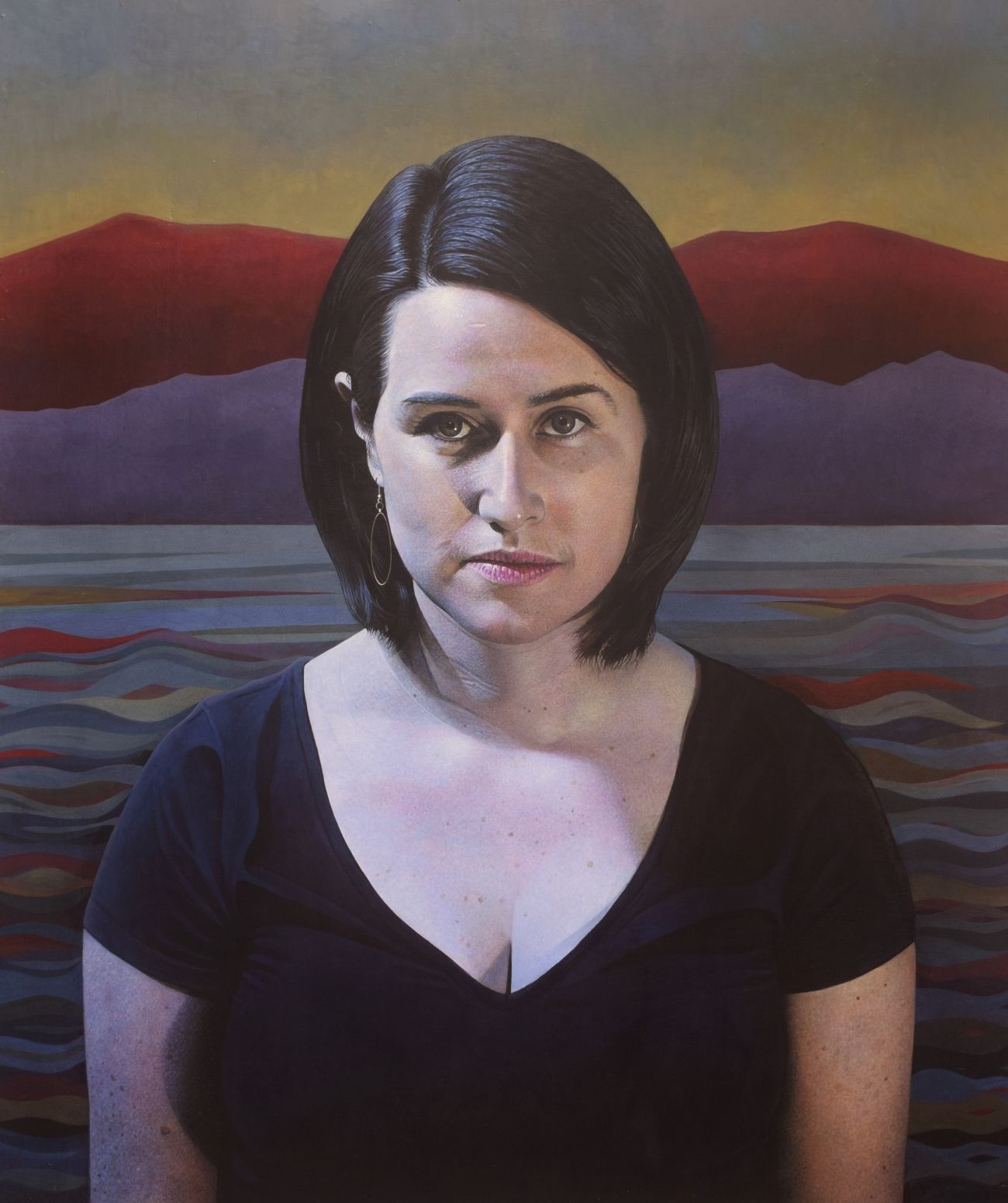 Woman in front of a colourful landscape of sea and mountains