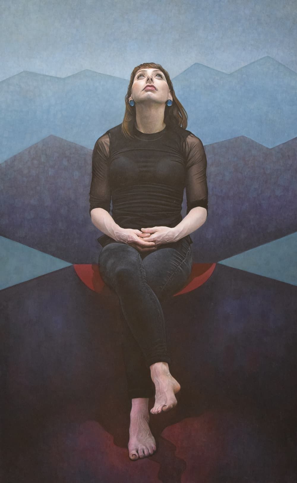 A young woman sitting cross-legged looking upwards. The background is an abstract landscape