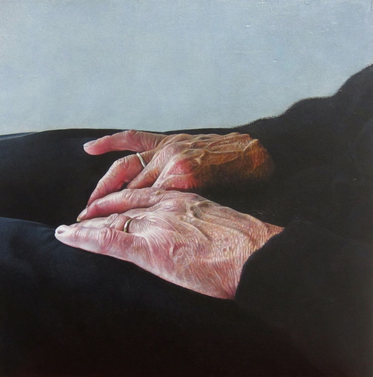 A womans hands in her lap